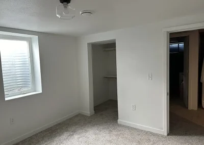 Newly built basement bedroom with walk-in closet and egress window.