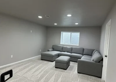 Large sectional in a finished basement makes for a great entertainment area.